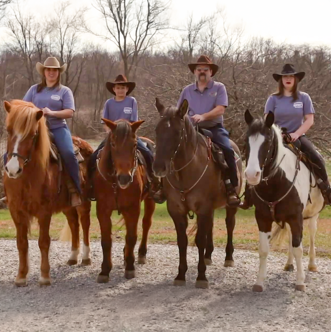 A photo of the family members who own and operate Cowboy's Heating and Air riding horses and wearing cowboy hats.